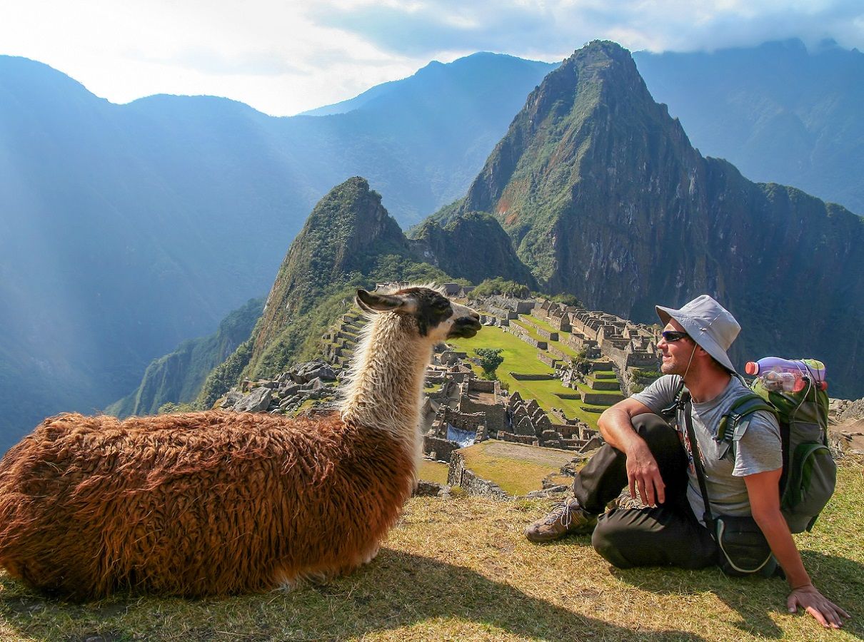Tourist and llama in Machu Picchu